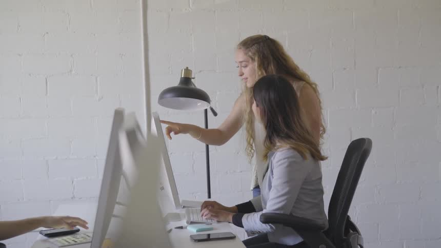 People are in a room looking at computers