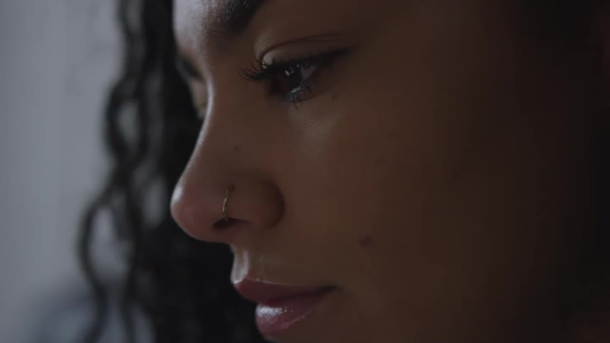 A woman looks at something out of the frame