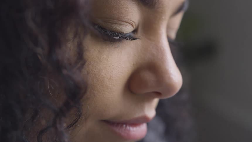 Woman looking down thoughtfully