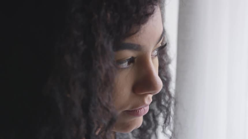 A young girls looks down