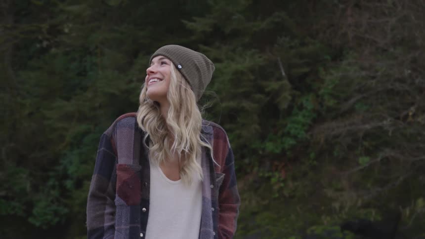 Girl spinning around in the woods