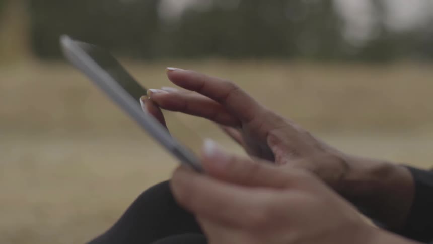 Woman scrolls on tablet