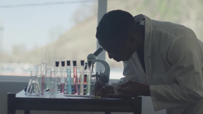 Man makes notes in lab