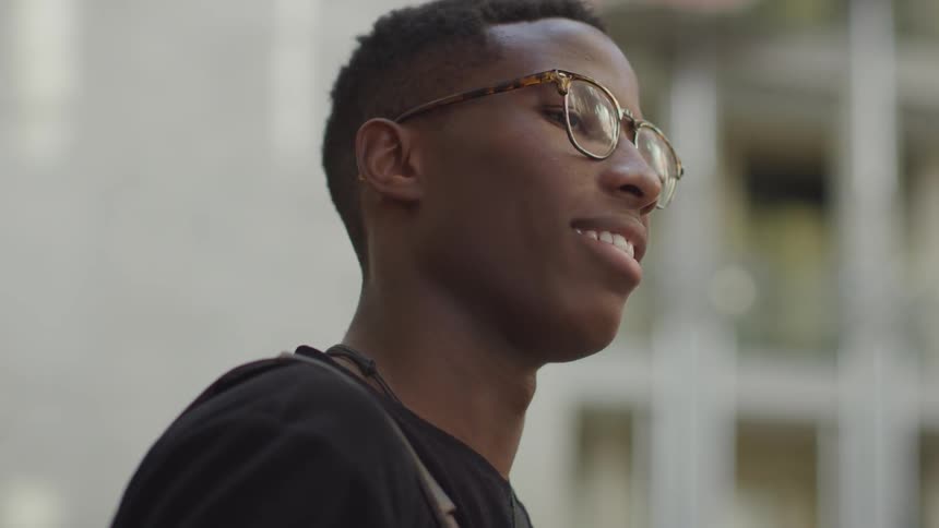 A young boy sits smiling