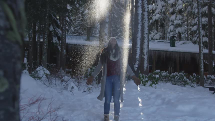 Woman throws snow into the air