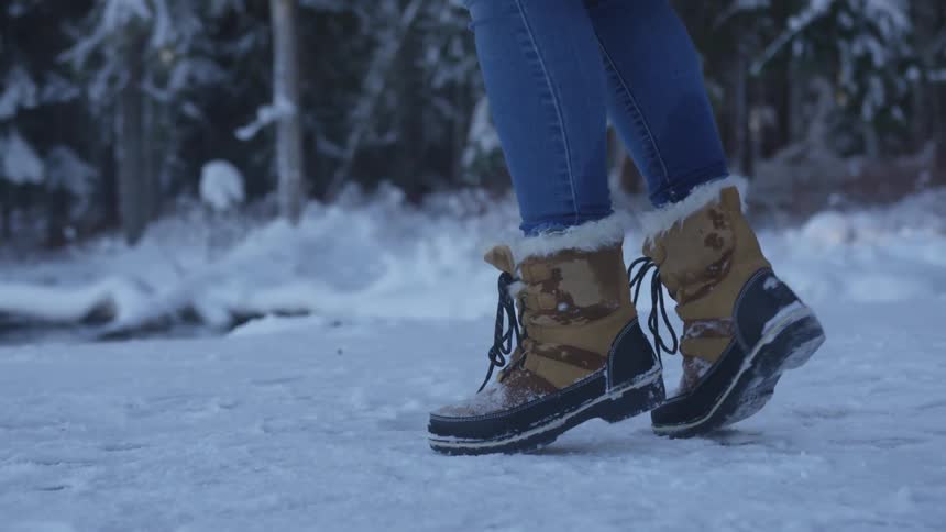 A person turns around in the ice by the woods