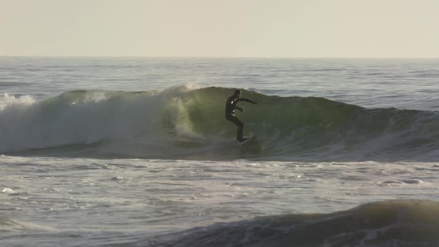 Man surfs the waves on a sunny day