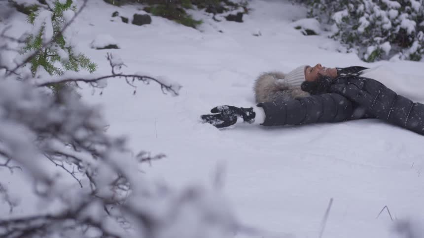 Woman lying down on snow