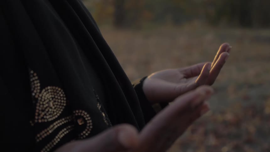 A person is holding their palms out to the sky