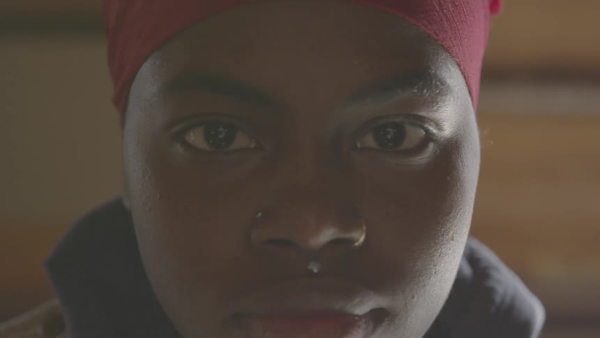 A black woman stares straight ahead
