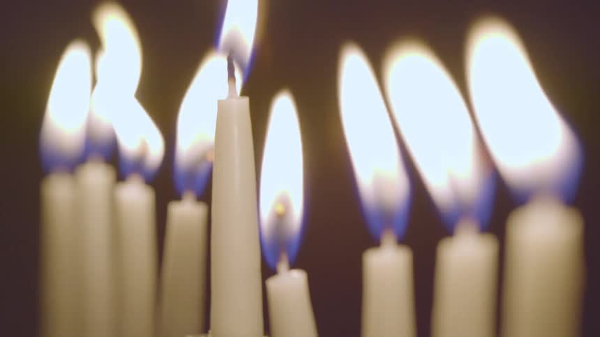 A line of candlesticks flicker in the wind
