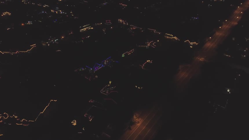 The camera flies over a city at night