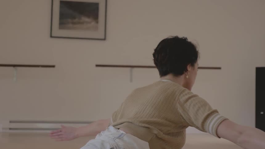 A caucasian female on the floor doing stretches