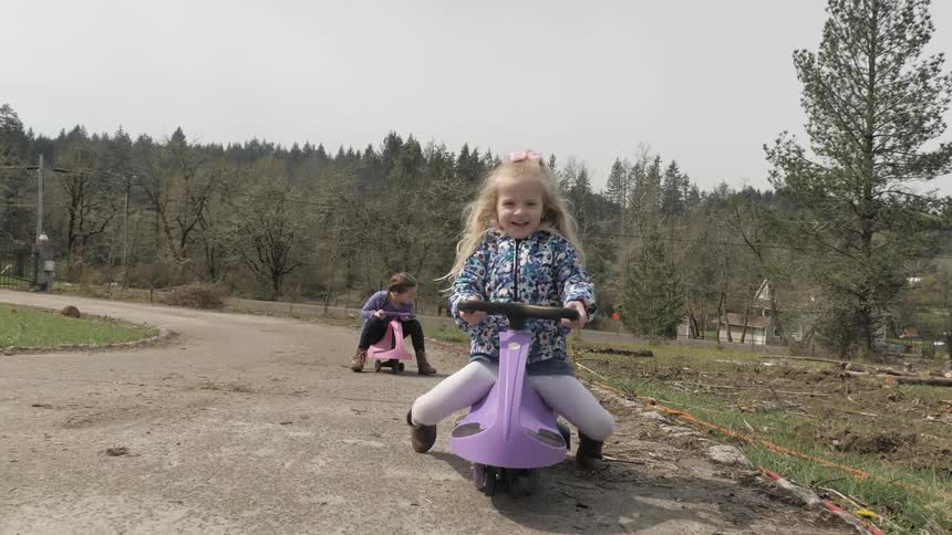 Children ride small bikes on concrete