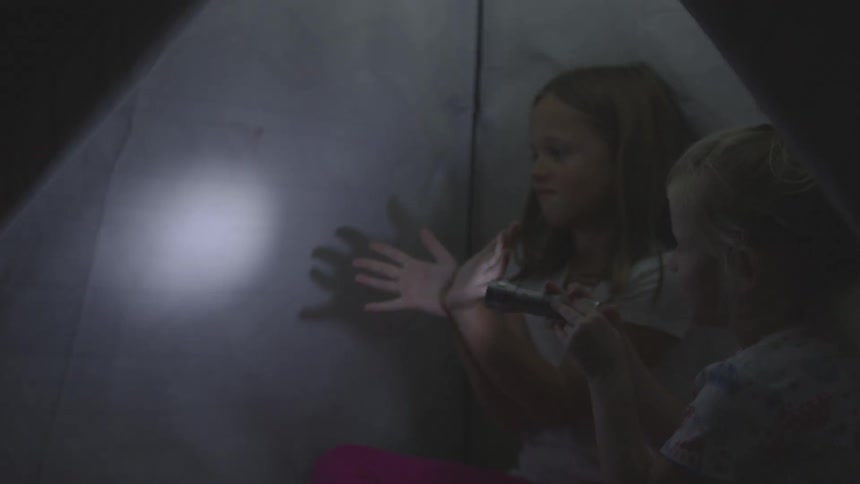 Children in tent make shadow puppets