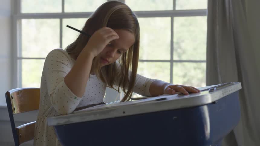 Young child writing at a desk