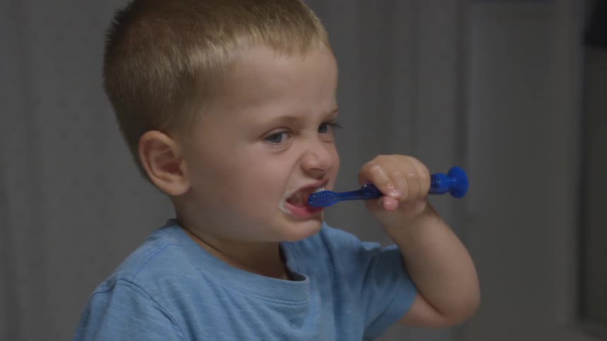 A young boy brushing his teeth