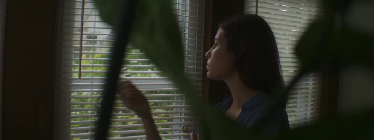 Woman looks out the window