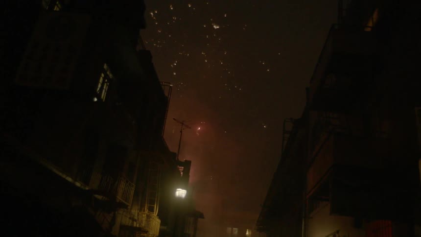 Fireworks lighting up the night sky over a city