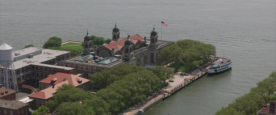 Ferry pulled up near architectural building