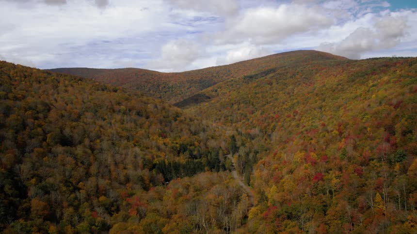 A valley between hills changing color with the seasons