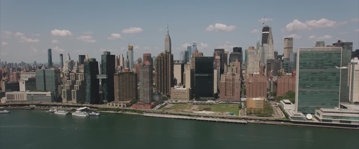 The camera flies next to a large dense city