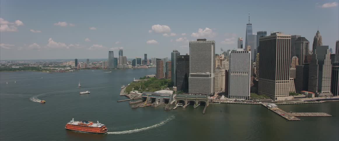 A boat pulls out from a city dock