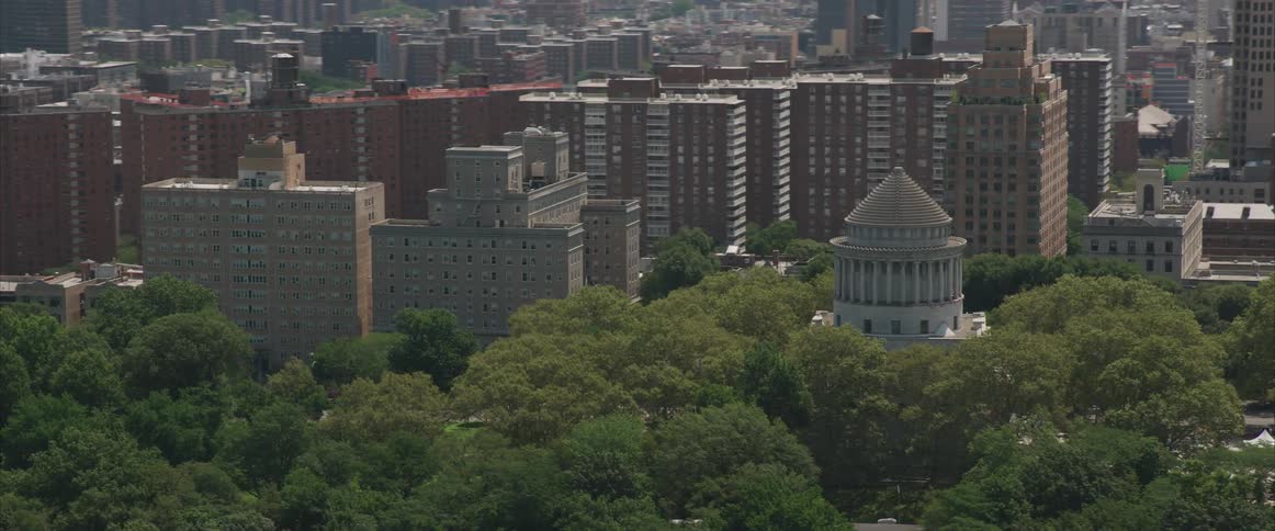 The camera flies over a large city
