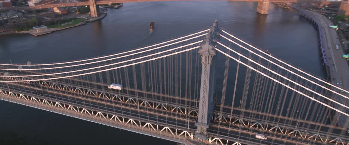 Cars cross suspension bridge connecting downtown