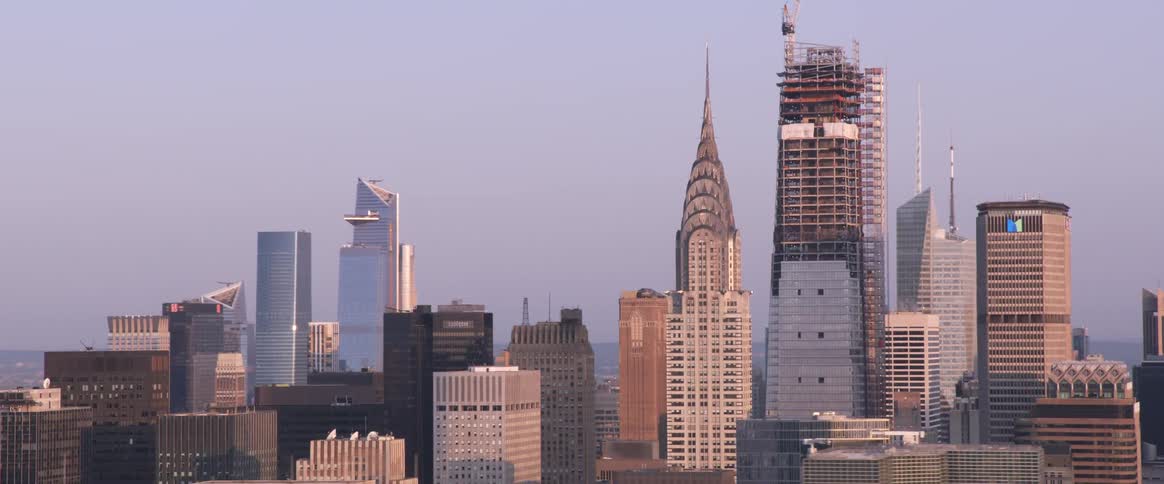 The camera flies by several skyscrapers