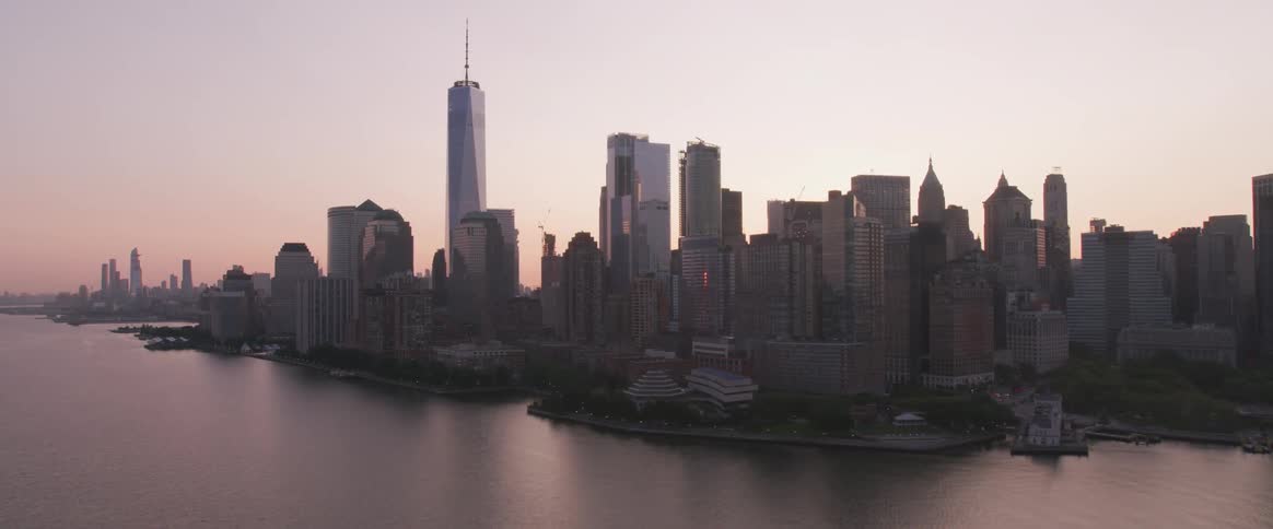 Downtown skyscrapers bordered by waterways at sunset