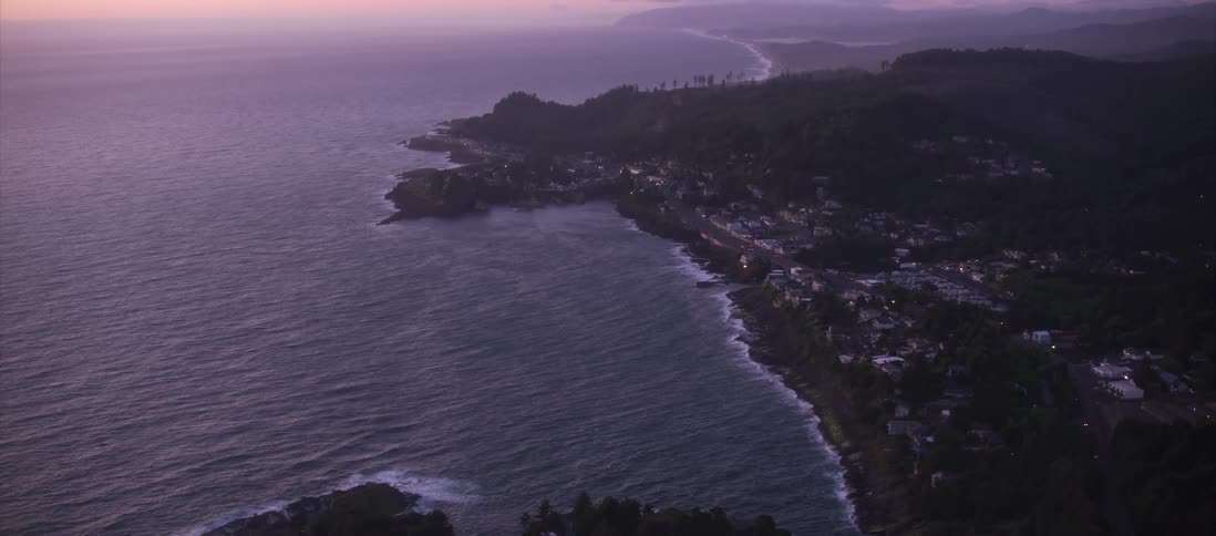 The coastline of a small city at sunset