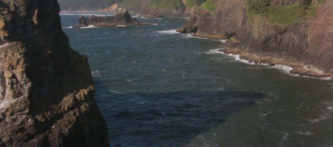 Waves crashing into a cliff side