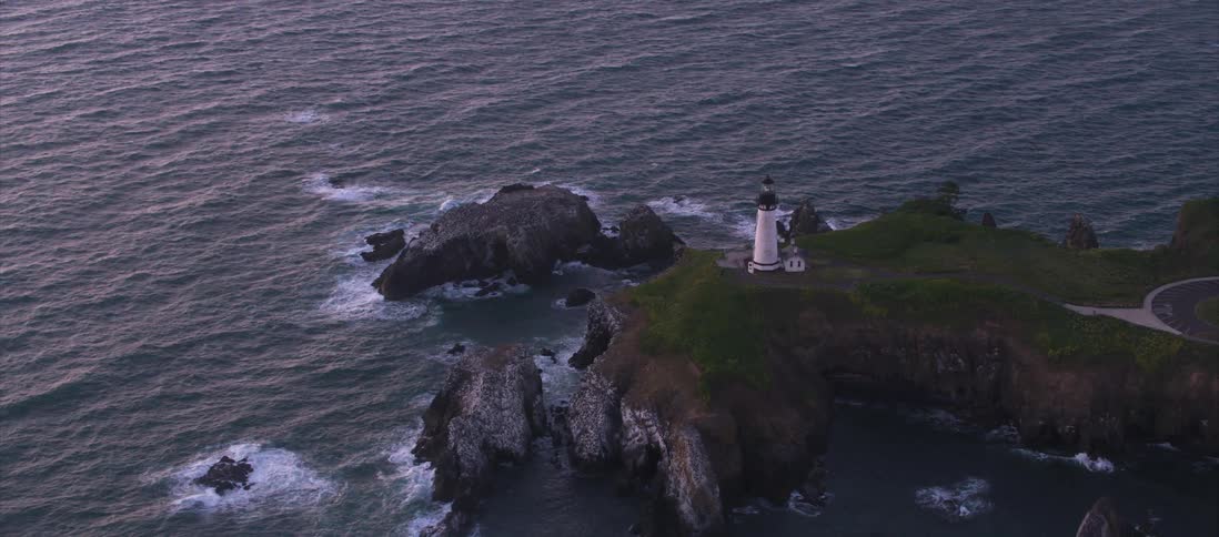 Aerial view of a lighthouse on a cliff at the coast