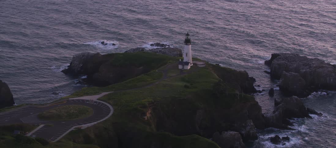 Beacon stands on a cliff surrounded by the ocean