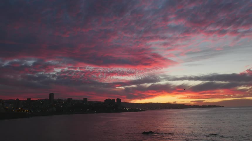 A coastline view of city at sunset
