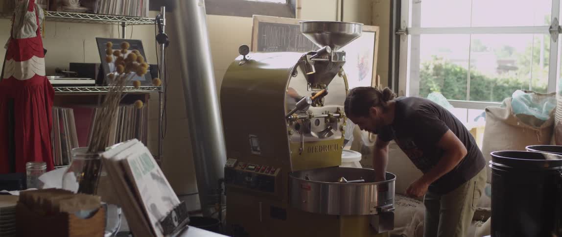 A man makes coffee with a machine
