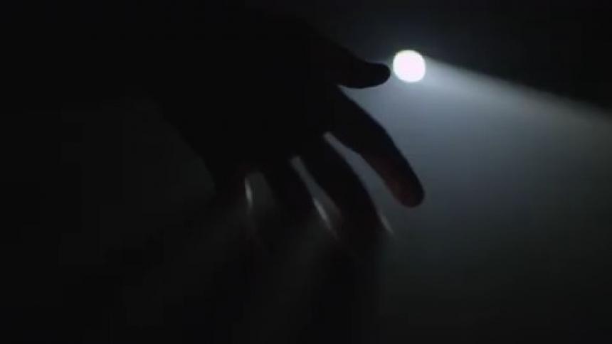 Shadow of a hand in front of blinking light