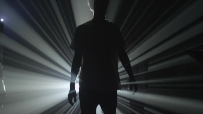 People walk around in the dark with a strobe light