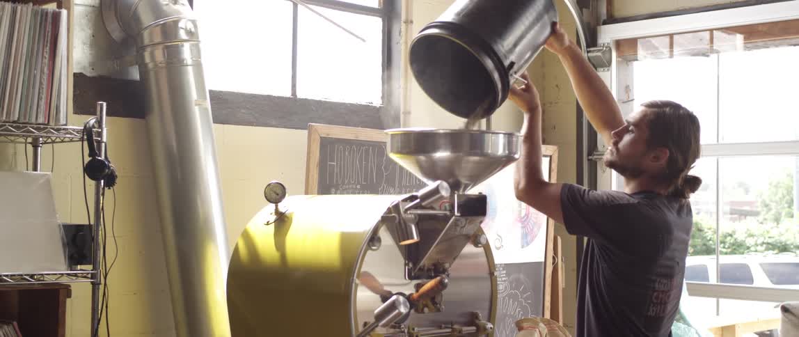 A person pouring stuff into a machine