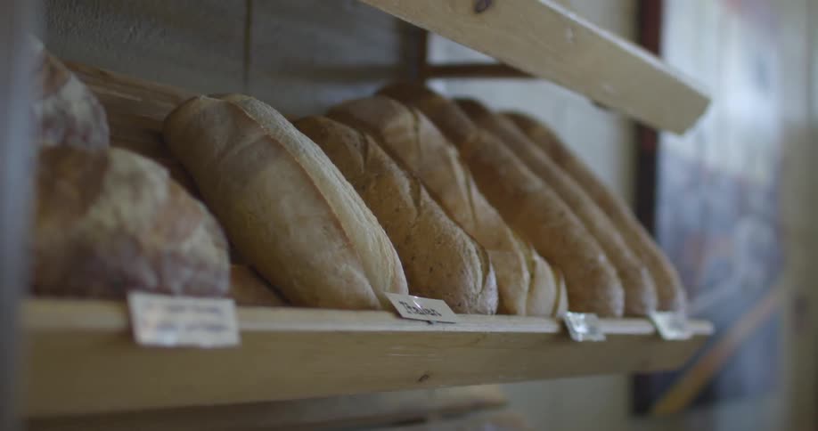 Bread is lined up on a shelf