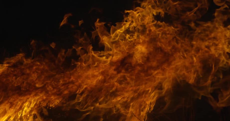 Bright orange flames blow to the right