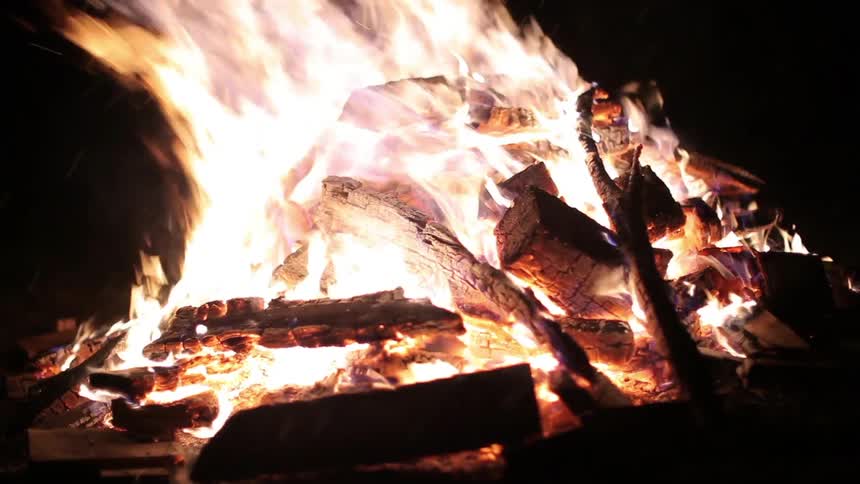 A log fire burns at night