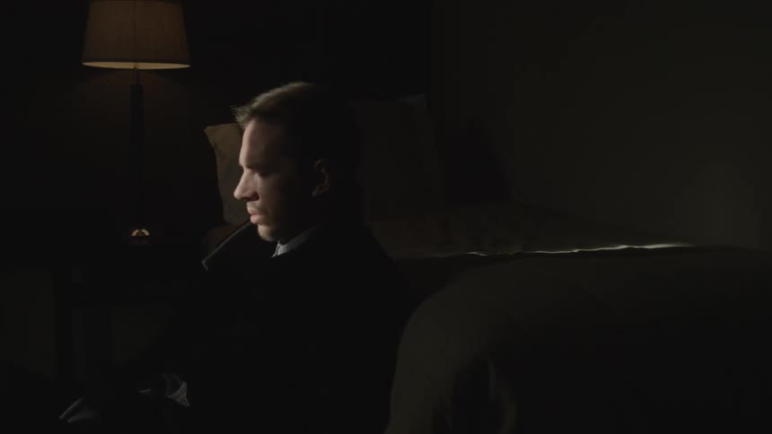Man looks around a dark room