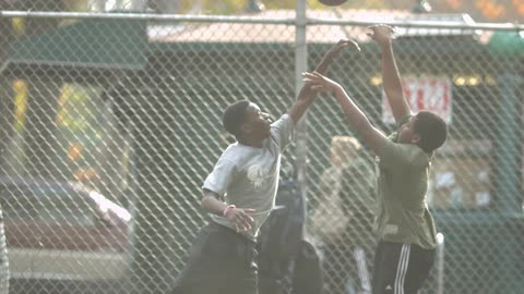 Two boys playing basketball