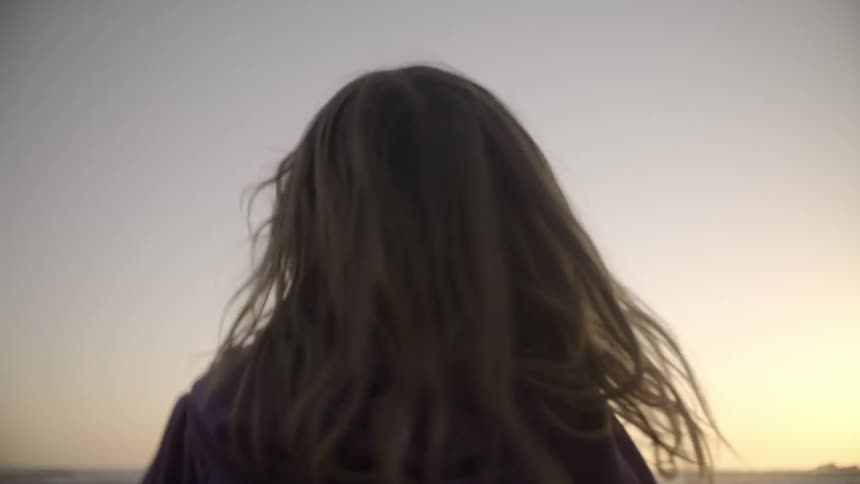 A girls spins on the beach