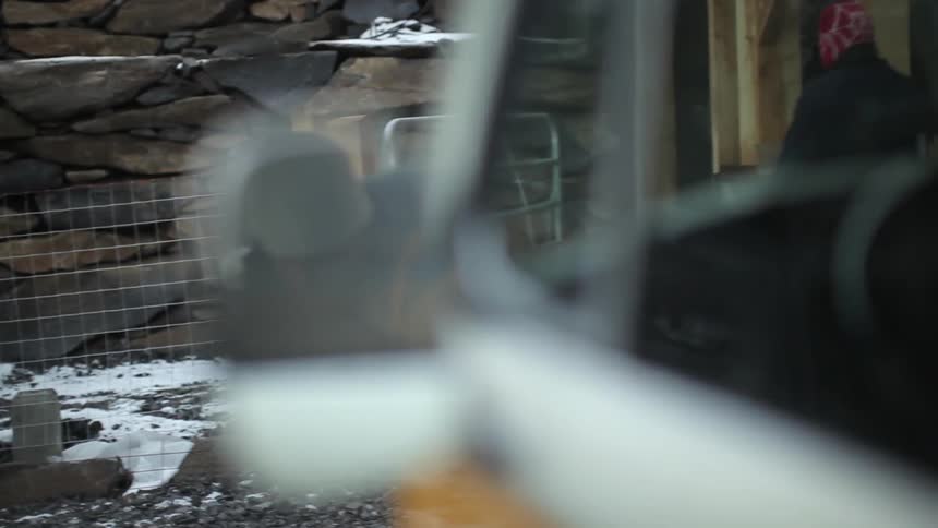 A person is reflected in a side view mirror