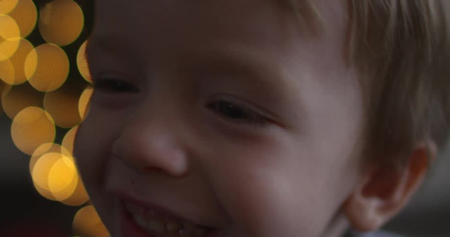 A young boy smiles and jumps