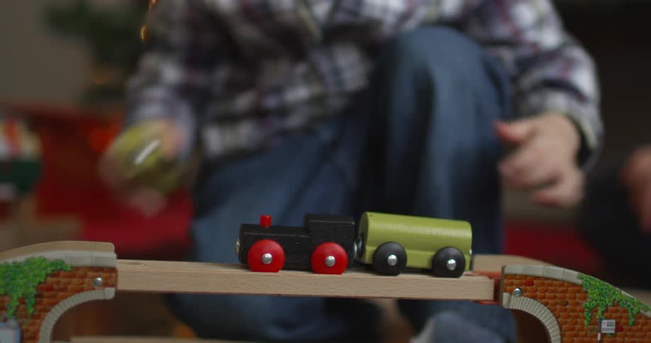 Little boy plays with toy train