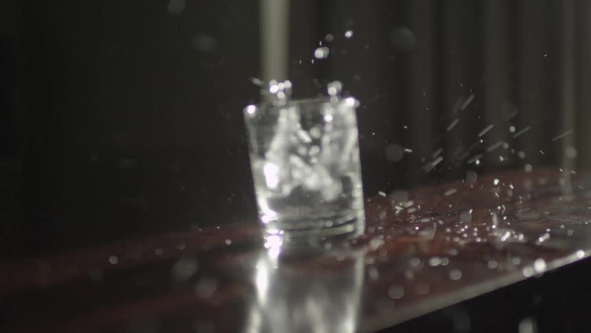 Glass of water spills everywhere on the bumping table